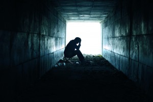 depressed man sitting in the tunnel