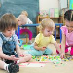 kids or children playing mosaic game in kindergarten room